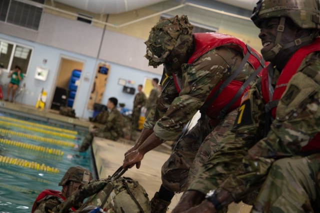 Pfc. Prince Ayarbah and James Weatherspoon, competitors representing 32nd Army Air and Missile Defense Command, Fort Bliss, Texas, pull rucks out of water at the Water Leader Reaction Course during the 2025 FORSCOM Best Squad Competition on Fort...