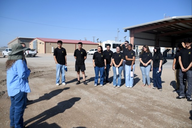 Local Army recruits talk with military vehicle testers at U.S. Army Yuma Proving Ground on August 14, 2025. At least one of the visitors has enlisted as a 91B Wheeled Vehicle Mechanic as a Military Occupational Specialty.