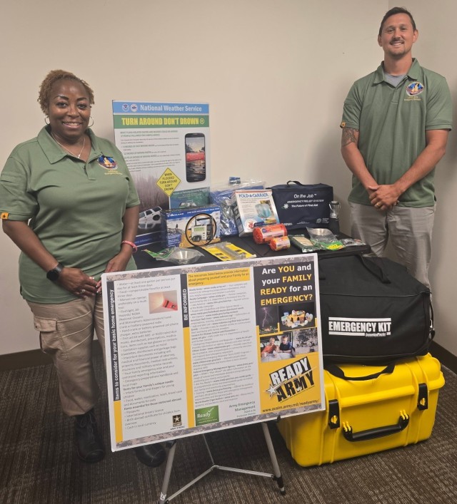 APG Installation Emergency Managers Essie Washington-Bennett and Andrew Perry stand next to their community outreach materials ahead of National Preparedness Month