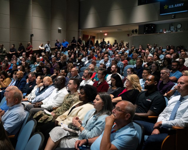 Members of the workforce watch the Aug. 18, 2025, U.S. Army Tank-automotive and Armaments Command town hall in an auditorium at the Detroit Arsenal.