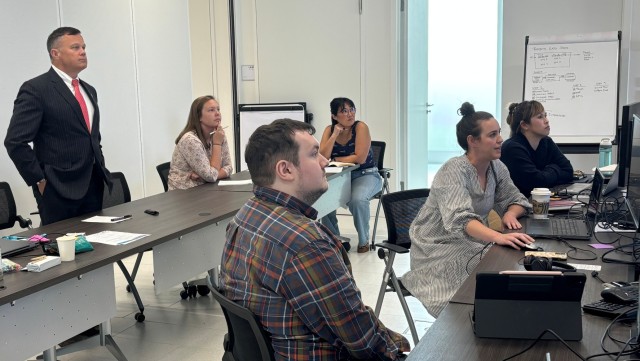 IMCOM-Europe Director Tommy R. Mize receives an out brief at the Innovation Forum, Aug. 22.