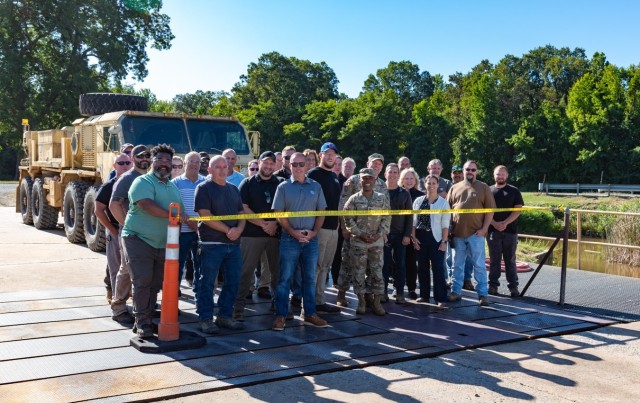 Moments before the ribbon cutting, the team at the U.S. Army Aberdeen Test Center pauses for a picture and to reflect on the partnerships and dedication that made the upgrade of the Perryman wash rack possible.