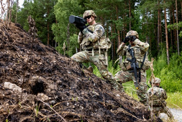 U.S. Army Sgt. Jason Thompson and Staff Sgt. Michael Lezama, military police officers assigned to the 615th Military Police Company, 709th Military Police Battalion, 18th Military Police Brigade, take down an unmanned aircraft system with a...