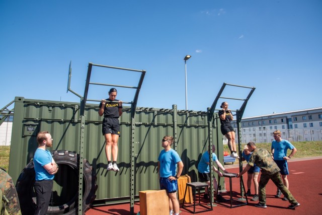 U.S. Soldiers hold a pullup to meet the time limit, a requirement to earn a German Armed Forces Military Proficiency Badge, Delitzsch, Germany, Aug. 18, 2025. The 7th Army Noncommissioned Officer Academy regularly partners with the Bundeswehr NCOA...