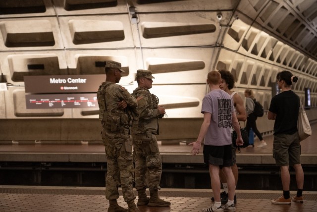 U.S. Soldiers with the Army National Guard speak with D.C. locals while patrolling Metro Center, Aug 26, 2025. About 2,000 National Guard members are supporting the D.C. Safe and Beautiful mission, providing critical support to the D.C....