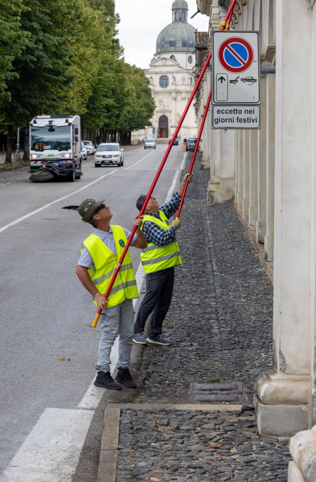 Members of the Vicenza Alpini Association clean the...