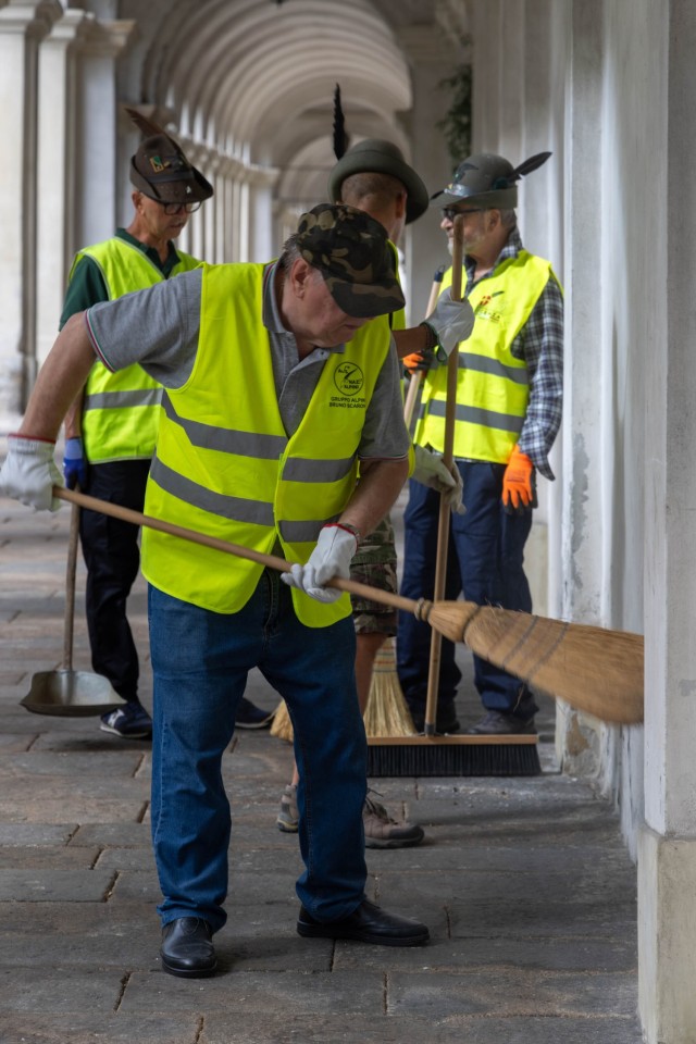 Members of the Vicenza Alpini Association clean the...