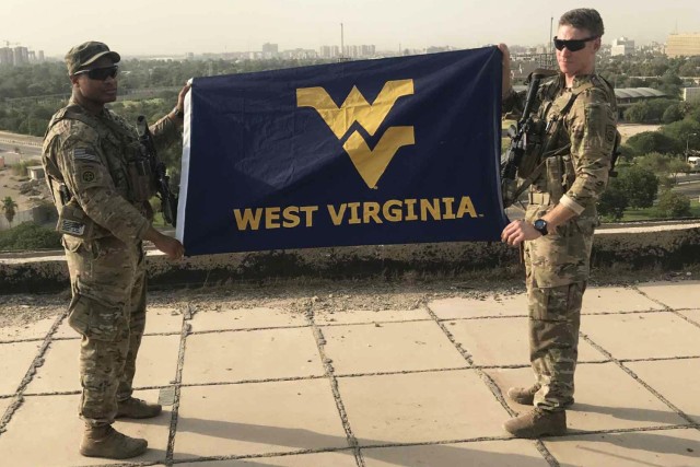 Army Spc. Darren Greene, left, poses for a photo in Baghdad in 2017.
