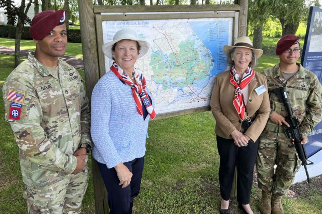 Army Staff Sgt. Darren Greene poses for a photo with the daughters of Army Lt. Gen. James M. Gavin in Normandy, France, on D-Day, June 6, 2024.
