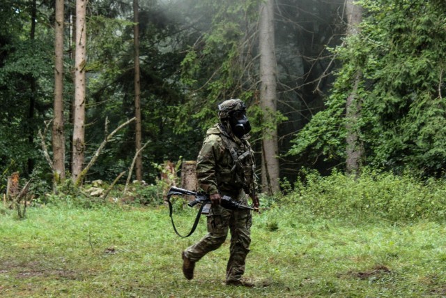 A soldier assigned to the headquarters element of 1st Cavalry Squadron, 2nd Cavalry Regiment, reacts to a simulated chemical attack at the Joint Multinational Readiness Center in Hohenfels, Germany, Sept. 8, 2025. The unit was being targeted by...