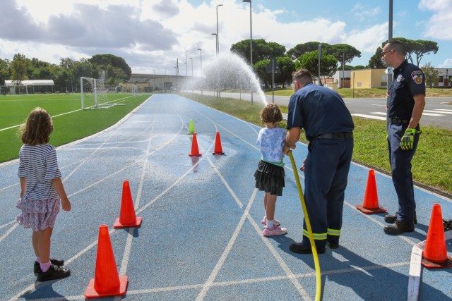 In commemoration of the 9/11/2001 attacks, the USAG-Italy Fire Department hosted a public Firefighter Challenge. This event includes a series of physical challenges, including a charged hose pull, a dummy drag, a Keiser sled, and a tire flip. The...