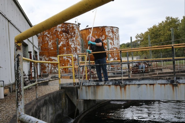 Radford Army Ammunition Plant Bioplant employee checking clarifiers, the last line of water treatment for wastewater.