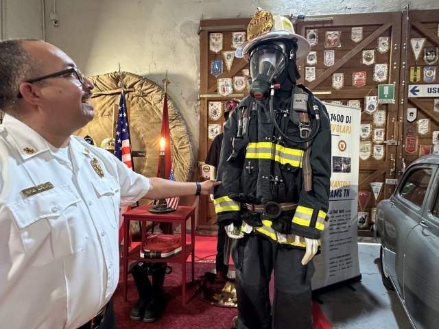 Fire chief Adam J. Montoya, U.S. Army Garrison Italy, Directorate of Emergency Services, observes the 9/11 exhibit during a visit to the Italian National Historical Museum of the Firefighters in Mantua, Italy, Sept. 19, 2025. On display, equipment...