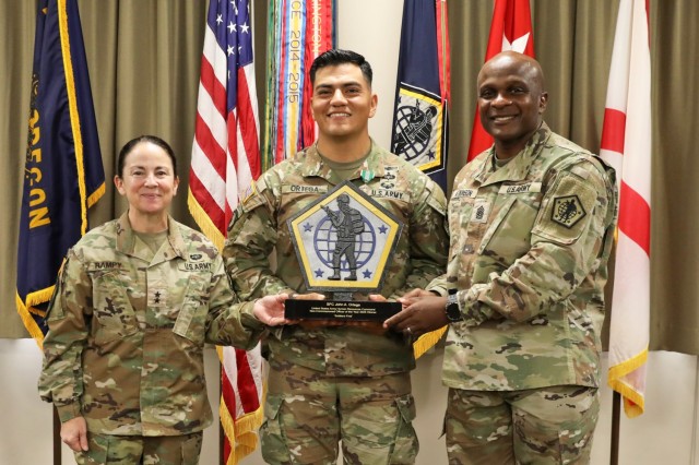 Gen. Hope Rampy, commanding general of the U.S. Army Human Resources Command, and HRC Senior Enlisted Advisor Command Sgt. Maj. Robert Atkinson take a photo with HRC Noncommissioned officer of the Year competition winner Sgt. 1st Class John Ortega...
