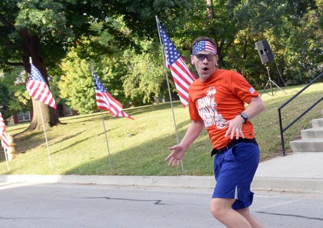 Lt. Col. Derek Thompson starts dancing to the music at the finish line of the Run/Walk for the Fallen while running backward Sept. 12, 2025, by the Resiliency Center at Fort Leavenworth, Kansas. After finishing the race, Thompson turned around to...