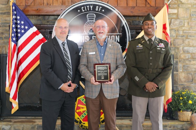 David Leinberger, Chief of Army Community Partnerships, Fort Benning Garrison Commander Col. J.D. Evans Garrison Commander, and Fort Benning Garrison Command Sgt. Maj. Martin J. Arguello, display an a