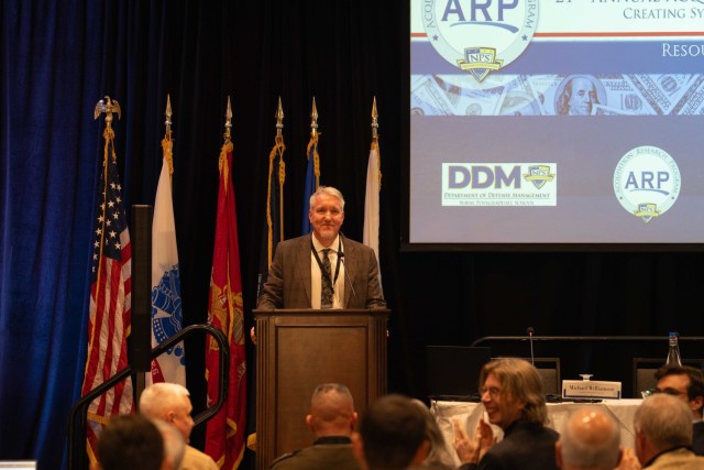 Robert Mortlock, Ph.D., associate chair of acquisition management at NPS, offers administrative remarks during the final day of the NPS Acquisition Research Symposium.