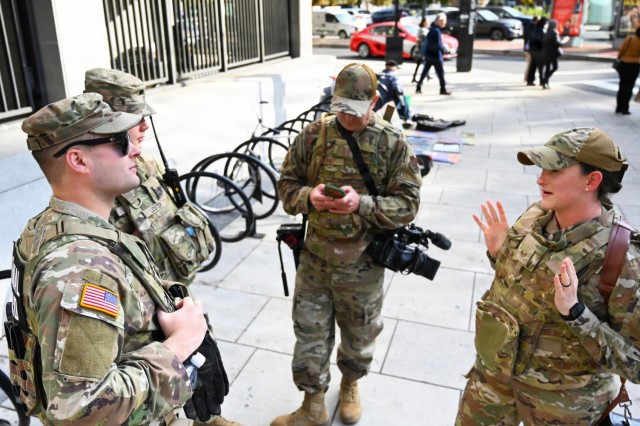 U.S. Army Sgt. Brady Wilson, left, and Spc. Jacob Lester speak with U.S. Air Force Master Sgt. Eugene Crist and Staff Sgt. Takara Williams, all assigned to the West Virginia National Guard, in Washington, D.C., Nov. 3, 2025. About 2,400 National...