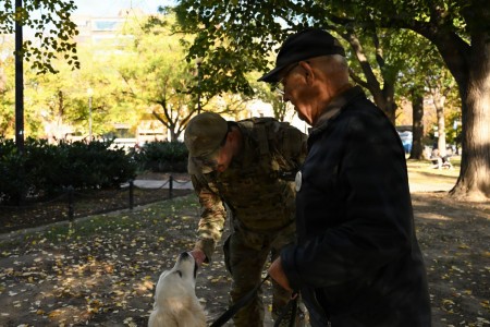 U.S. Air Force Tech. Sgt. Andrew Enriquez, a public affairs specialist with the 113th Wing, District of Columbia Air National Guard, interacts with a local resident and his dog, Bailey, during a presence patrol in Dupont Circle, Washington, D.C.,...