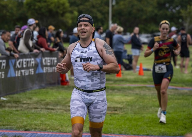 James Paska, first sergeant of the Seattle Recruiting Company, crosses the finish line during the 2025 Armed Forces Triathlon Championship.