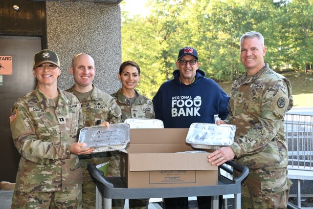 The Keller Army Community Hospital Command team poses with the Regional Food Bank of New York volunteer as Keller donates frozen repurpose prepared and wholesome foods.