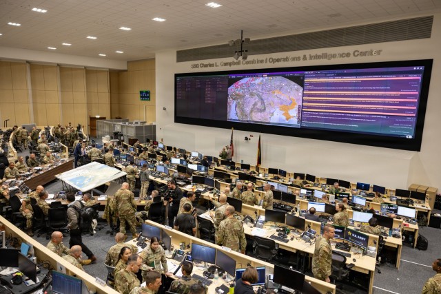 NATO service members monitor operations inside a Combined Operations and...