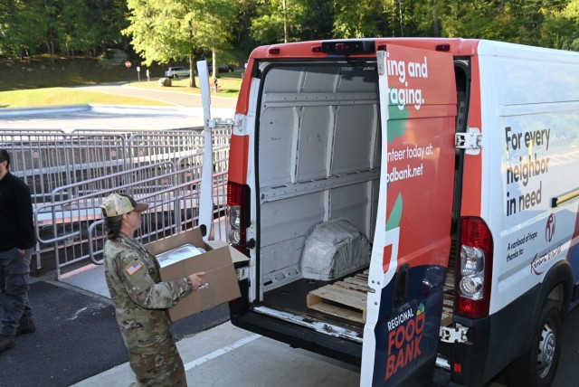 Capt. Jacquelyn Contant, Chief, Nutrition Care Division, Keller Army Community Hospital, delivers the box of frozen repurpose prepared and wholesome foods to the Regional Food Bank of New York vehicle
