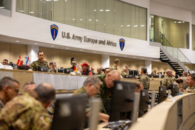NATO service members monitor operations inside a Combined Operations and...