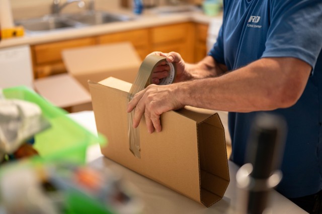 A military mover tapes a customer’s item during a Permanent Change of Station on Scott Air Force Base, Illinois, July 17, 2025. The Department of Defense established the Permanent Change of Station Joint Task Force to improve the moving...