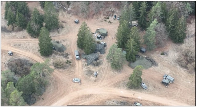 Figure 3. A vulnerable Battalion main command post (MCP) with multiple tents and vehicles positioned outside the tree line, fully exposed.