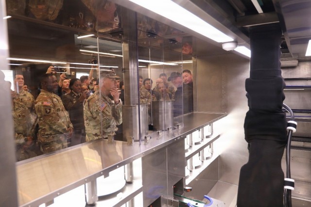Community members watch the Market19 robot operate