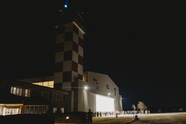Family members await the return of the 1st Battalion, 58th Aviation Regiment 1st Battalion Soldiers from a 9-month deployment to the Horn of Africa on Cairns Army Airfield Nov. 19.