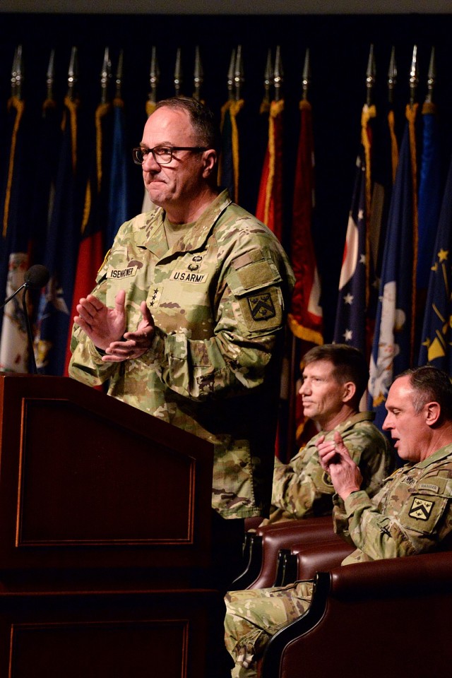 Incoming Combined Arms Command Commanding General Lt. Gen. James P. Isenhower III applauds civilian employees for hanging in there during the government shutdown with ceremony host Transformation and Training Command Commanding General Gen. David....