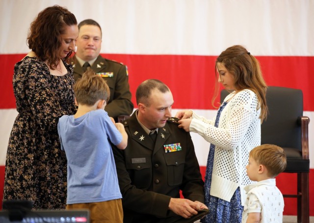 Capt. William Fritts gets his rank pinned by his wife 1st Sgt. (Ret.) Stephanie Fritts and their kids during a commissioning ceremony on June 2, 2025, at the Pierce County Readiness Center, Camp Murray, Wash. Fritts earned the rank of Captain...