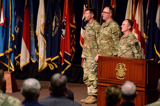 Ceremony host Transformation and Training Command Commanding General Gen. David. M. Hodne, Combined Arms Command Commanding General Lt. Gen. James P. Isenhower III and CAC Command Sgt. Maj. Shawn Carns sing the Army Song at the conclusion of...