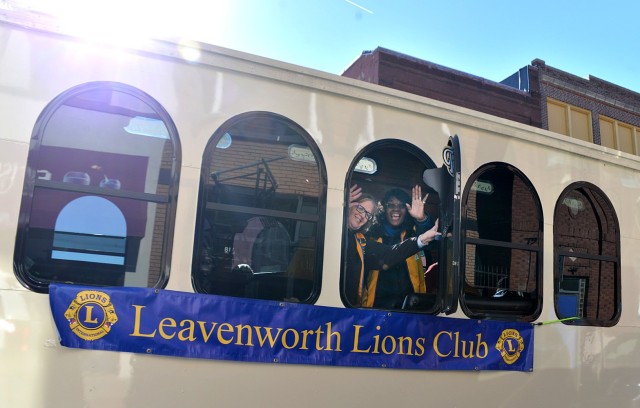 Brendale Wakeley and Wendy Miranda wave from a bus loaded with Leavenworth Lions Club members as they make their way along the parade route Nov. 11, 2025, in downtown Leavenworth, Kansas. Photo by Emilio Gutierrez/Fort Leavenworth Lamp Intern