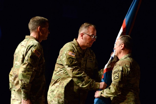 Incoming Combined Arms Command Commanding General Lt. Gen. James P. Isenhower III returns the colors to CAC Command Sgt. Maj. Shawn Carns after receiving them from Transformation and Training Command Commanding General Gen. David. M. Hodne, left,...