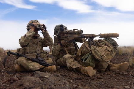 U.S. Army reconnaissance Soldiers (from right to left) Sgt. Rafael Lopeza a sniper and Pfc. Benjamin Walker of Multipurpose Company, 3rd Squadron, 4th Cavalry Regiment, 25th Infantry Division, sit atop an observation point on Pōhakuloa Training Area Hawaii on Nov. 14, 2025.