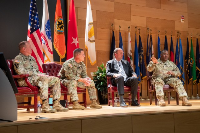 (From right to left) U.S. Army Communications-Electronics Command Chief Warrant Officer 5 Kevin I. Banks discusses artificial intelligence training while CECOM Deputy to the Commanding General Mr. Nicholaus Saacks, CECOM Command Sgt. Maj. Jay A....
