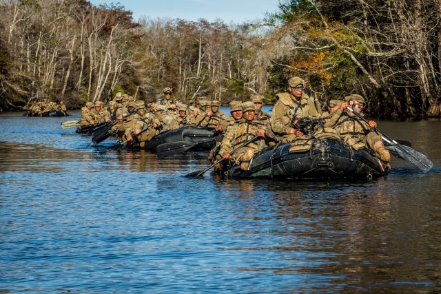 U.S. Army Ranger Course students conduct small boat operations during the Swamp Phase, Dec. 5, 2019, at Camp James E. Rudder on Eglin Air Force Base, Florida. Each boat has a squad automatic weapon gunner who provides security while the rest...