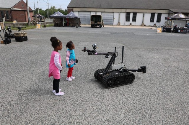 Two girls look at CBRN Sensor Integration on Robotic Platforms semi-autonomous robotics technology, part of a display by the JPEO-CBRND during Aberdeen Proving Ground’s Demonstration Days May 19-20, 2023.