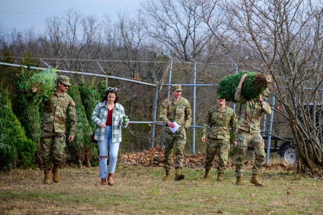 Soldiers and family choose their live holiday trees at the Auto Skills Center, during the 2024 Trees for Troops event. This year, the program returns to Fort Leonard Wood Dec. 12 and 13.