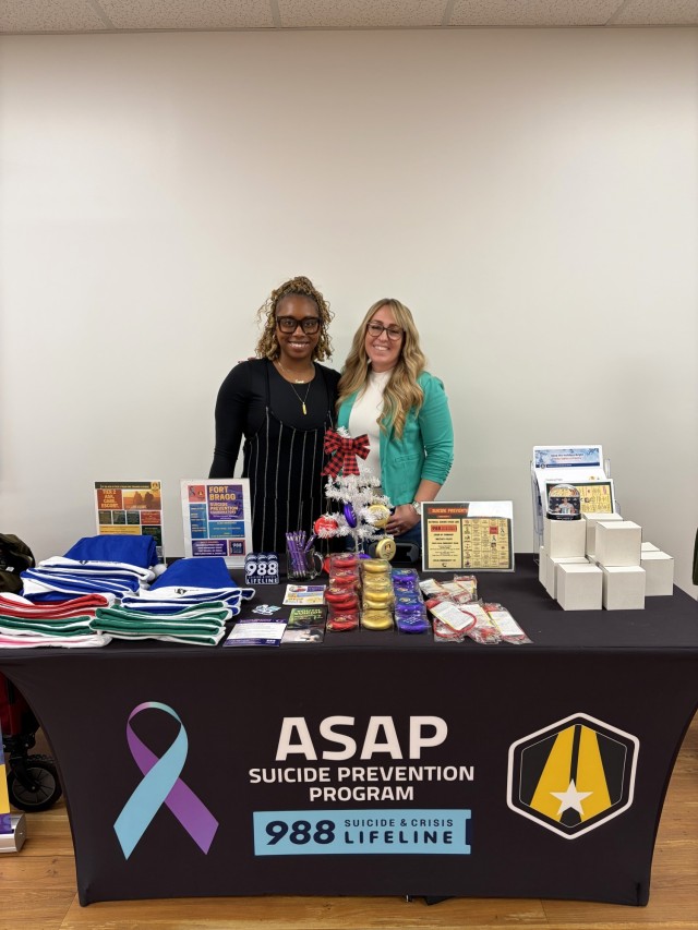 Jamila Ford (left) and Alise Menchaca (right), Fort Bragg Suicide Prevention Program Coordinators, at the Snow Globe of Hope tabling event Dec. 10.