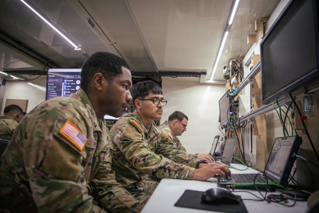 Spc. Cameron Fudge (left) and Sgt. Gael Varela (center), node operators both assigned to 4th Infantry Division Artillery, 4th Infantry Division, await a fire mission from division headquarters during Ivy Sting III, December 9, 2025, Fort Carson,...