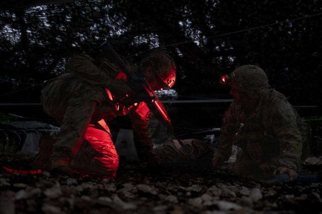 U.S. Army Staff Sgt. Devin Lindberg, left, and Staff Sgt. Michael Griffin, 188th Medical Battalion combat medics, participate in the Litter Obstacle Course as part of the U.S. Army Medical Center of Excellence Best Medic Competition on Fort Sam...