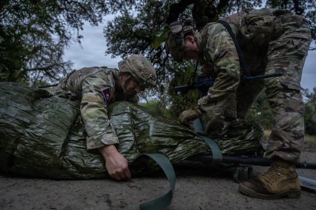 U.S. Army Staff Sgt. Devin Lindberg, left, and Staff Sgt. Michael Griffin, 188th Medical Battalion combat medics, participate in the Litter Obstacle Course as part of the U.S. Army Medical Center of Excellence Best Medic Competition on Fort Sam...
