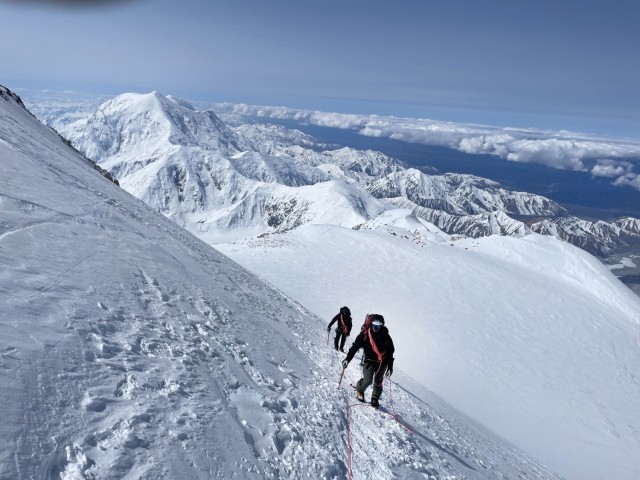 CPT Roy Schindler and MSG Corey Donnelly traverse the “Autobahn,” a steep slope at 18,000 feet, as they ascend to the summit of Denali in June 2025. (Photos courtesy of authors)