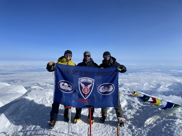 The authors — CPT Edward Kwait, MSG Corey Donnelly, and CPT Roy Schindler — celebrate their summit of Denali on 12 June 2025.
