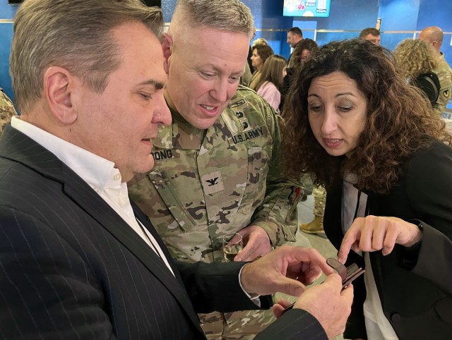 Silvia Trevisan, right, a USAG Italy bilingual ambassador, helps during a conversation between Col. Vaughn Strong, commander of USAG Italy and the Mayor of Nove, Luca Rebellato.