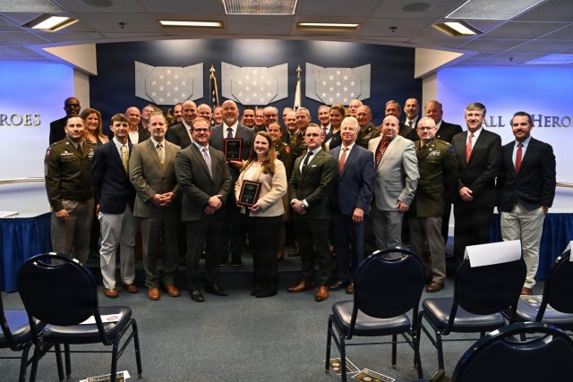 U.S. Soldiers and civilian community partners pose for a group photo after the Army Community Partnership Award ceremony at the Pentagon, Arlington, Virginia, Dec. 9, 2025. The annual ceremony showcases how installations and local communities work...